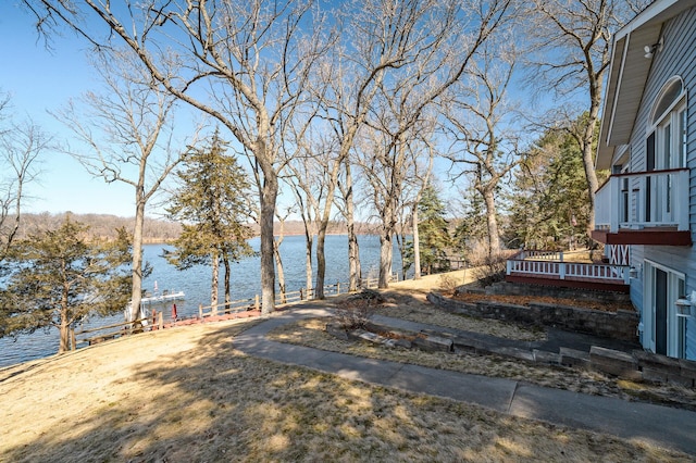 view of yard with a boat dock and a water view