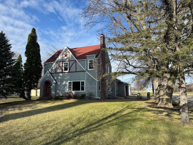 201 2nd St W, Chokio, MN 56221 - tudor house with a chimney, a front lawn, and stucco siding