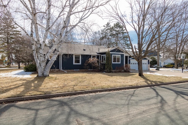 single story home featuring concrete driveway, an attached garage, a front lawn, and roof with shingles