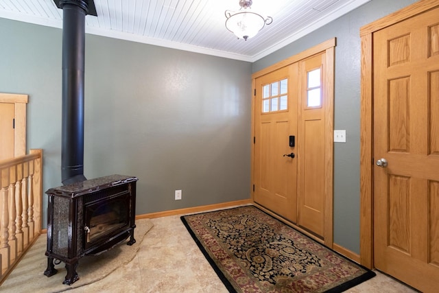 entryway featuring a wood stove, ornamental molding, and baseboards