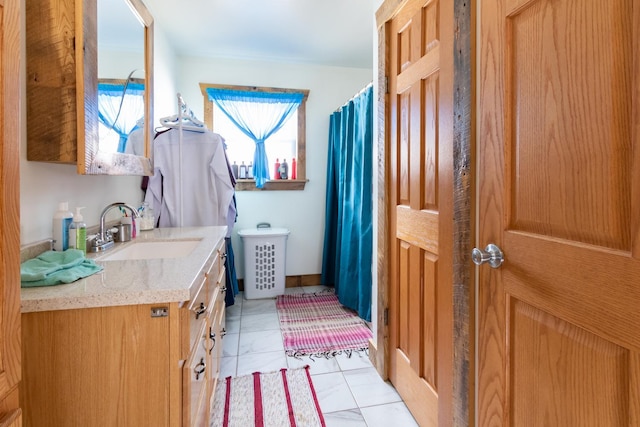full bath featuring baseboards, vanity, and a shower with curtain
