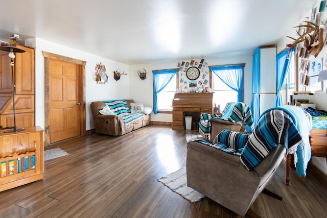 living area with baseboards and wood finished floors