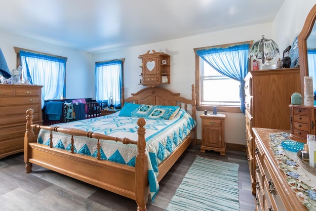 bedroom with baseboards and wood finished floors
