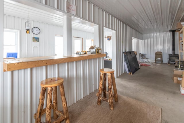 dining area featuring concrete flooring and metal wall