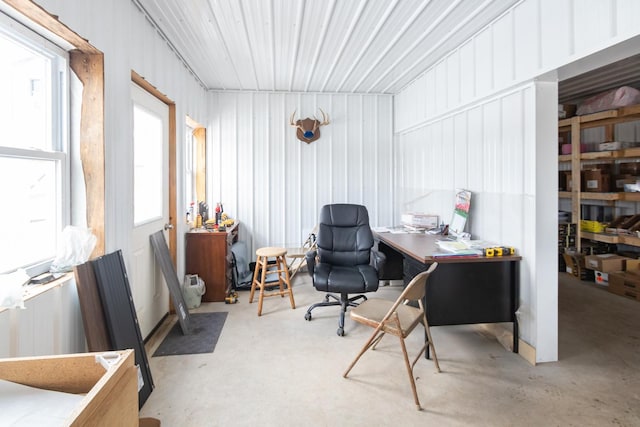 office space with concrete flooring and metal wall