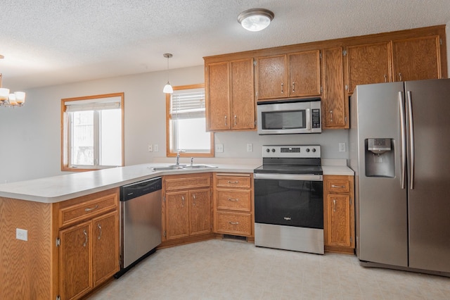 15174 Cates Lake Dr, Savage, MN 55372 - kitchen with brown cabinets, appliances with stainless steel finishes, and a sink