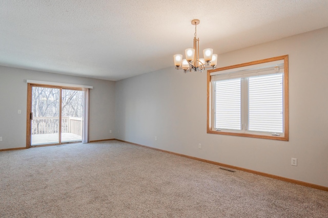 15174 Cates Lake Dr, Savage, MN 55372 - spare room featuring baseboards, visible vents, carpet, and a chandelier