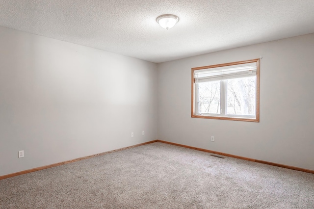 15174 Cates Lake Dr, Savage, MN 55372 - carpeted empty room featuring a textured ceiling, visible vents, and baseboards