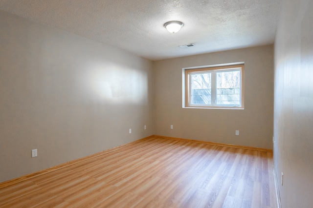 15174 Cates Lake Dr, Savage, MN 55372 - unfurnished room with a textured ceiling, light wood-type flooring, visible vents, and baseboards