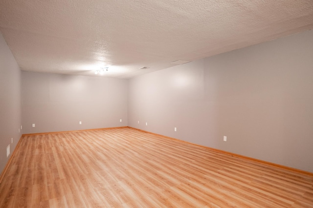 15174 Cates Lake Dr, Savage, MN 55372 - spare room featuring light wood finished floors, baseboards, and a textured ceiling