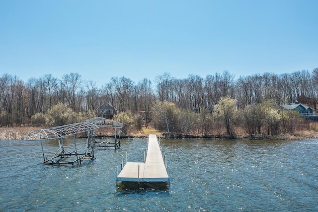 dock featuring a water view and a forest view