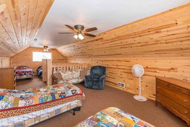 bedroom with wooden walls, carpet, lofted ceiling, and ceiling fan
