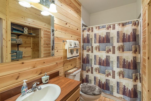 full bath featuring toilet, wooden walls, vanity, and a shower with shower curtain