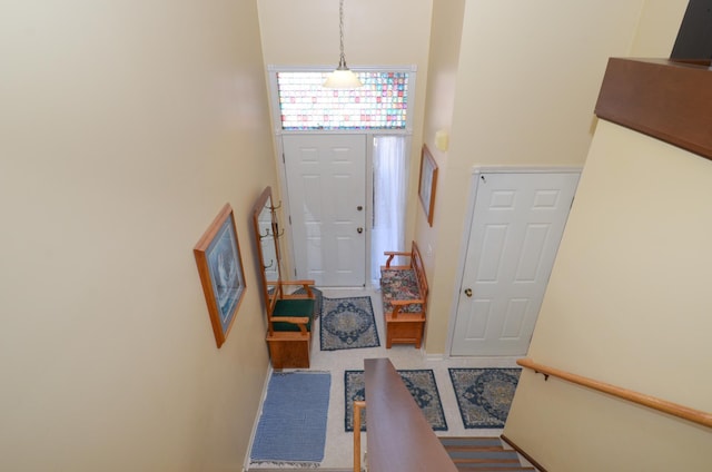 foyer entrance featuring a towering ceiling and baseboards