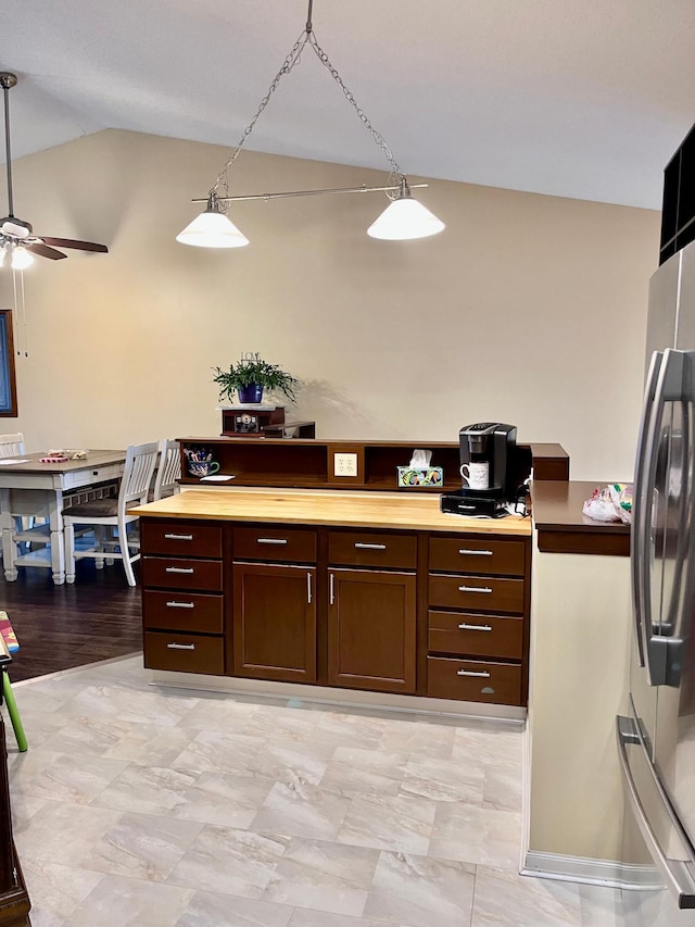 kitchen with freestanding refrigerator, vaulted ceiling, ceiling fan, and light countertops