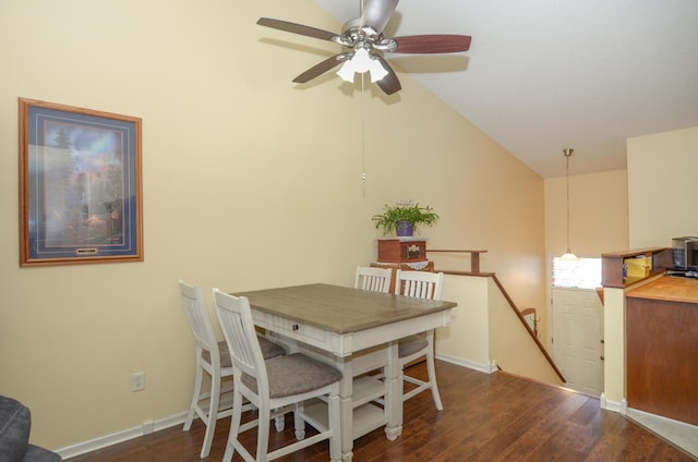 dining area with wood finished floors, a ceiling fan, lofted ceiling, and baseboards