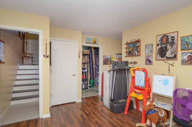rec room with wood finished floors and baseboards