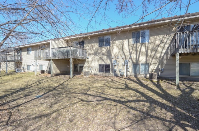 back of property featuring central air condition unit and a wooden deck