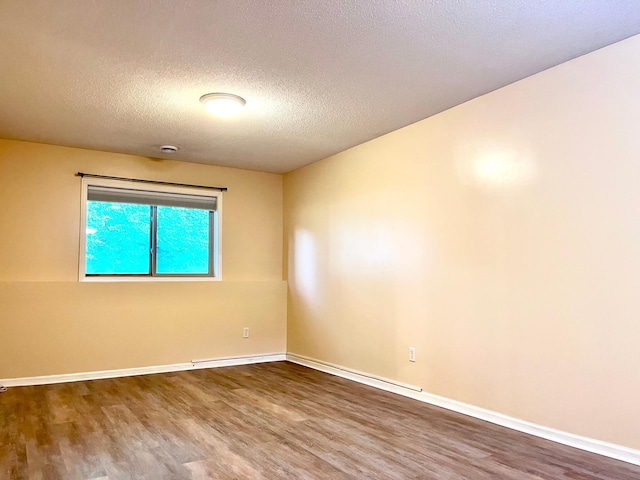 953 14th Ln SE, Cambridge, MN 55008 - spare room with wood finished floors and a textured ceiling