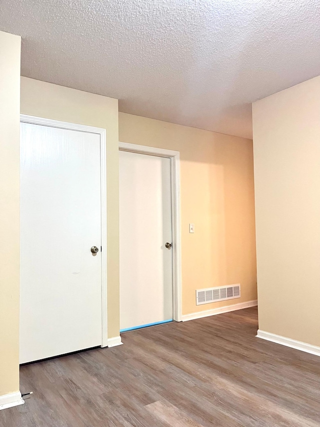 953 14th Ln SE, Cambridge, MN 55008 - empty room with wood finished floors and a textured ceiling