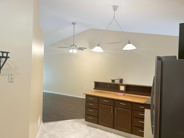 953 14th Ln SE, Cambridge, MN 55008 - kitchen with freestanding refrigerator, vaulted ceiling, dark brown cabinets, ceiling fan, and hanging light fixtures