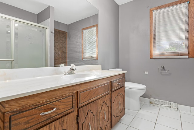 4418 Chowen Ave N, Robbinsdale, MN 55422 - bathroom featuring vanity, toilet, a stall shower, tile patterned floors, and baseboards