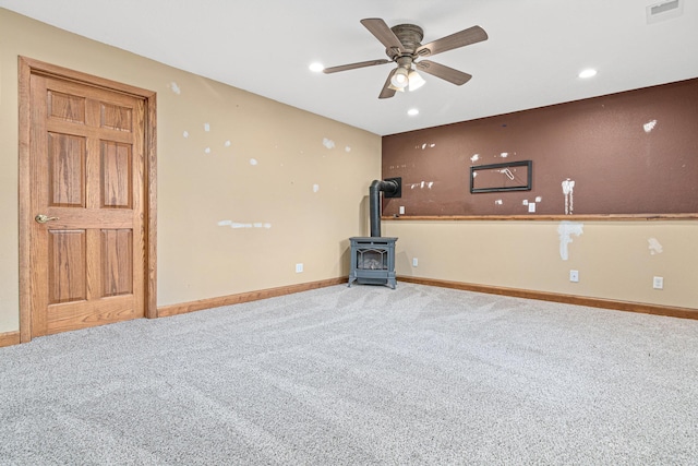 4418 Chowen Ave N, Robbinsdale, MN 55422 - unfurnished living room featuring carpet, a wood stove, a ceiling fan, baseboards, and recessed lighting