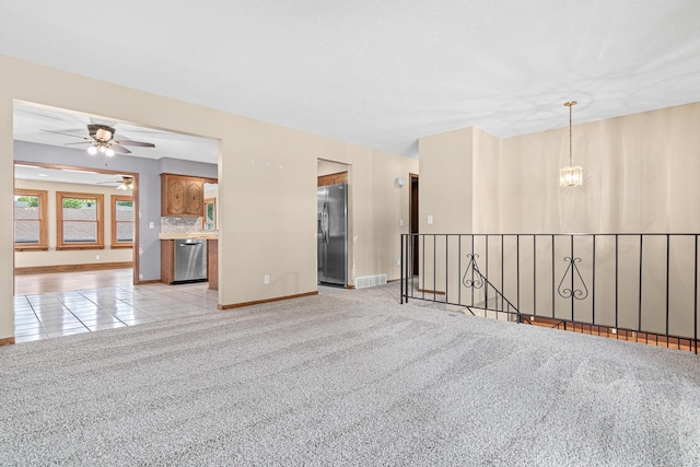 4418 Chowen Ave N, Robbinsdale, MN 55422 - spare room with a chandelier, light colored carpet, and a ceiling fan