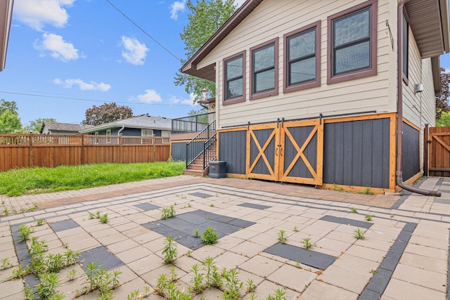 4418 Chowen Ave N, Robbinsdale, MN 55422 - fenced backyard featuring a patio area and stairs