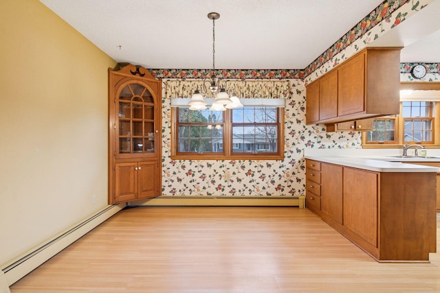 kitchen featuring light wood-style floors, wallpapered walls, a chandelier, and baseboard heating