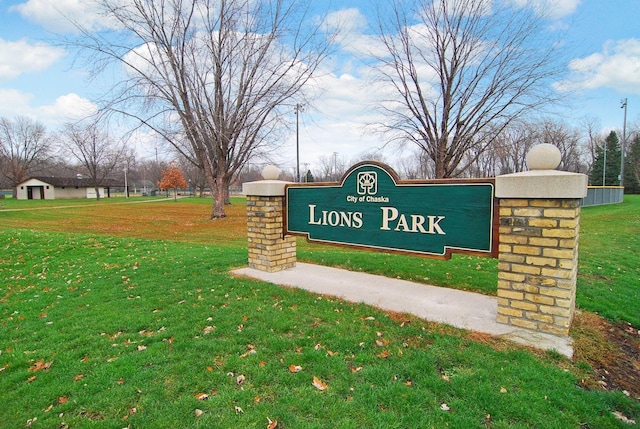 community / neighborhood sign with a lawn