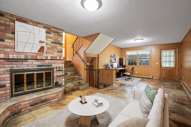 office space featuring stone tile flooring, baseboard heating, a brick fireplace, and a textured ceiling