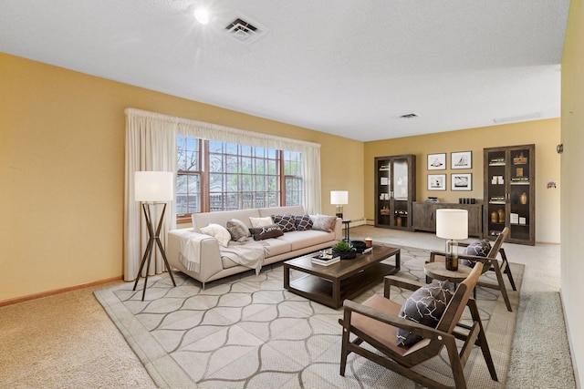living area featuring visible vents, baseboards, and light carpet