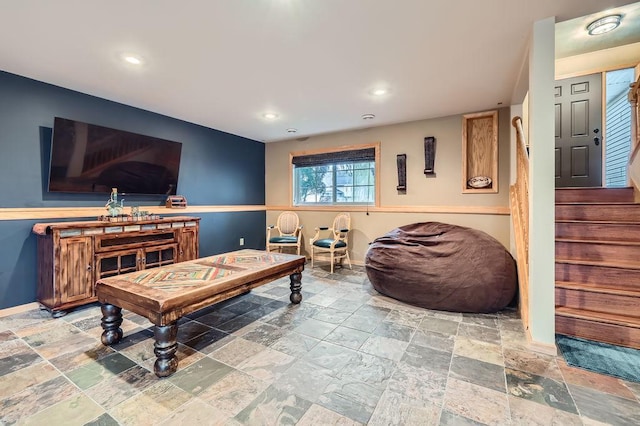 living room with recessed lighting, stone tile floors, and baseboards