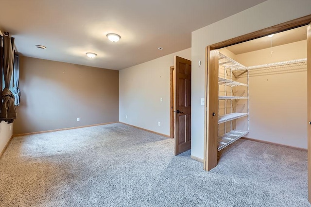 unfurnished bedroom featuring baseboards and carpet
