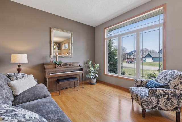 sitting room featuring baseboards and wood finished floors