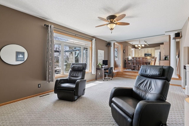 living room featuring a textured ceiling, baseboards, visible vents, light colored carpet, and ceiling fan with notable chandelier