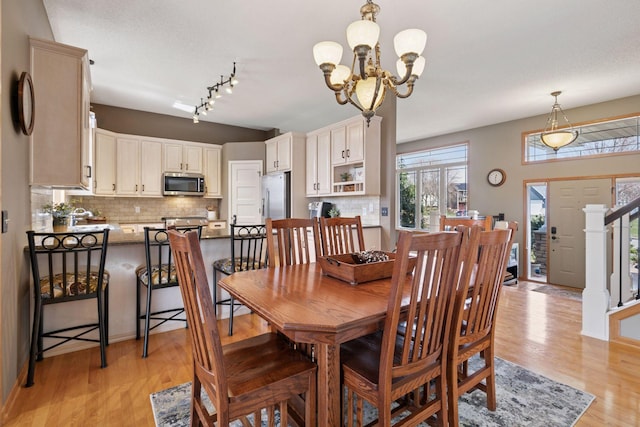 dining space featuring an inviting chandelier and light wood-style floors