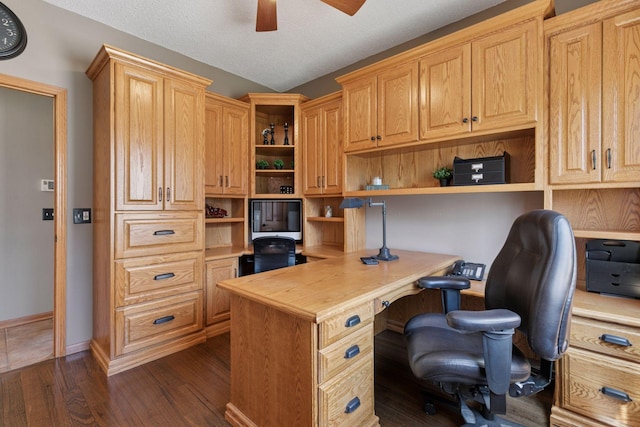office area with a ceiling fan, a textured ceiling, built in study area, baseboards, and dark wood-type flooring