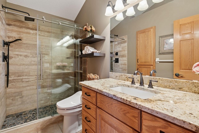 full bath with vanity, toilet, a stall shower, and tile patterned floors