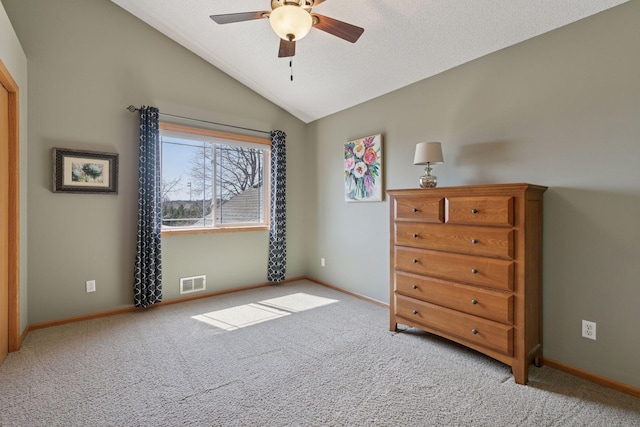 bedroom featuring lofted ceiling, visible vents, and carpet flooring