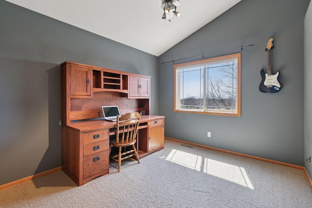 home office featuring vaulted ceiling, visible vents, and light carpet