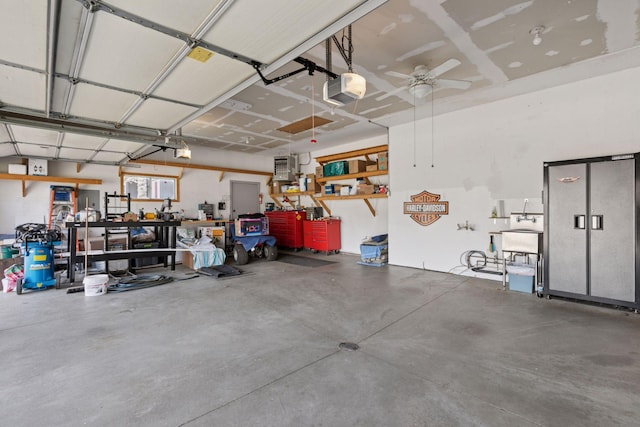 garage with ceiling fan, a garage door opener, and a workshop area
