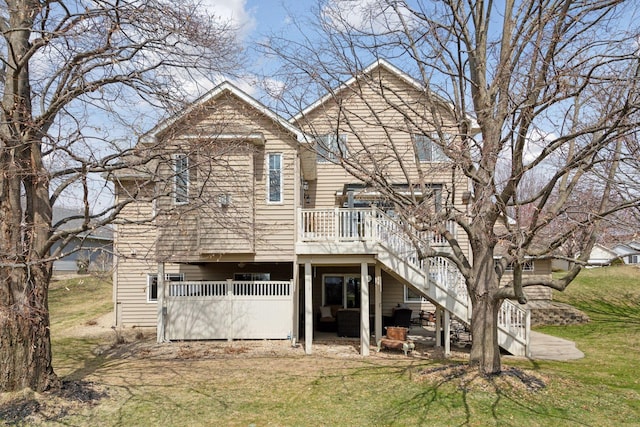 back of property featuring a patio area, stairs, a yard, and a deck