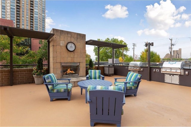 401 1st St Unit 308, Minneapolis, MN 55401 - view of patio featuring a warm lit fireplace, exterior kitchen, and area for grilling
