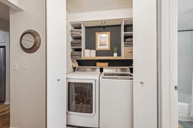 401 1st St Unit 308, Minneapolis, MN 55401 - clothes washing area featuring independent washer and dryer and wood finished floors