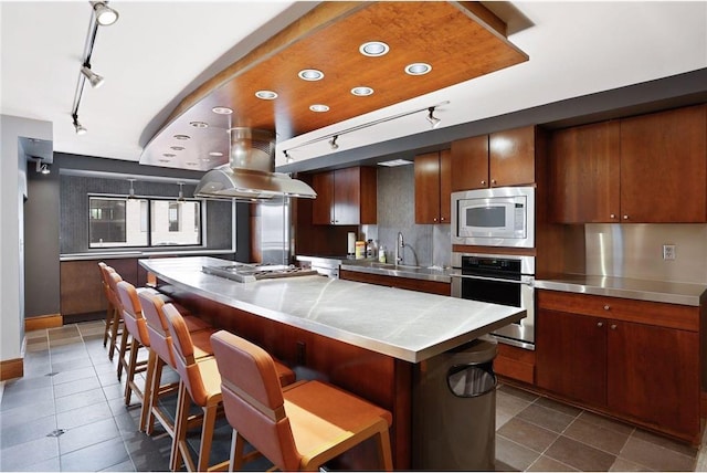 401 1st St Unit 308, Minneapolis, MN 55401 - kitchen with stainless steel counters, track lighting, stainless steel appliances, and island exhaust hood