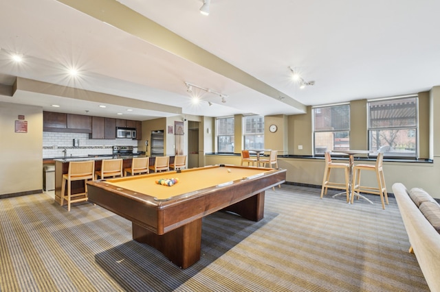 401 1st St Unit 308, Minneapolis, MN 55401 - rec room featuring track lighting, light carpet, billiards, baseboards, and a sink