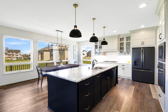 4737 130th Ln NE, Blaine, MN 55449 - kitchen with black fridge, oven, a sink, stainless steel microwave, and glass insert cabinets