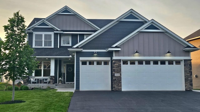 4737 130th Ln NE, Blaine, MN 55449 - craftsman inspired home featuring board and batten siding, stone siding, asphalt driveway, and a front lawn